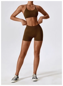 Detail view of mocha seamless sports bra and high-waist shorts on professional model