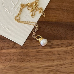 Elegant 925 sterling silver gold necklace featuring a round white pearl pendant