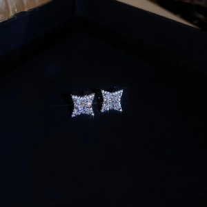 Macro shot of sparkling silver star-shaped stud earrings with premium zircon stones