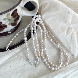 Detailed view of S925 silver lobster clasp and extension chain on pearl necklace