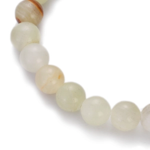 Macro detail of natural stone beaded bracelet with polished light green and white jade beads
