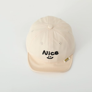Detail of nice smiley face embroidery and soft brim on beige cotton baby sun hat