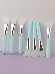 Detailed view of 7-piece silicone face mask brushes with blue handles and silver ferrules