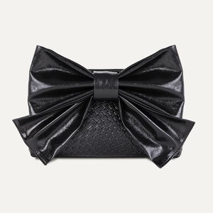 Chic black bow-knot crossbody handbag with woven texture and glossy crinkled leather