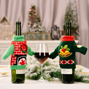 Festive knitted Christmas wine bottle covers with fireplace and golden bell designs