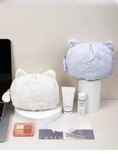 Detail of floral lace embroidery and cute cat ears on cat-shaped makeup organizers