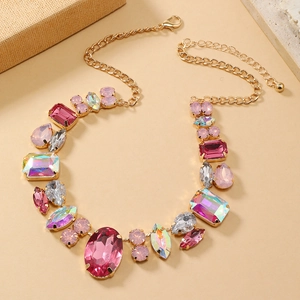 Macro shot of colorful gemstone necklace with large pink and iridescent faceted crystals