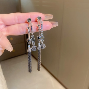 Macro detail of vintage tassel earrings with silver chains and crystal stones