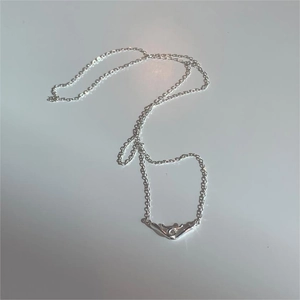 Detailed close-up of a minimalist 925 sterling silver necklace with unique clasp pendant
