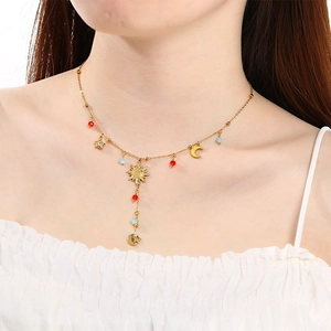 Gold stainless steel necklace with sun moon star pendants and colorful beads on a model