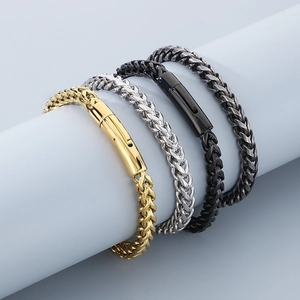 Detail of stainless steel dragon bone bracelets in gold, silver, and black finishes