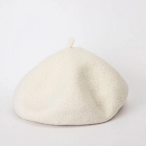 Close-up of cream wool beret showing soft textured fabric and classic autumn shape