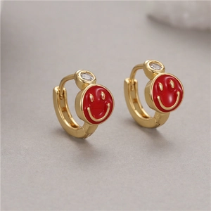 Detail of gold hoop earrings with red enamel smiley faces and sparkling clear zircons