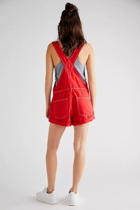 Back view of red cotton denim overalls showing pocket placement and cross-strap details