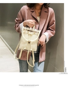 Lifestyle view of clear PVC backpack with beige inner pouch and gold twist lock