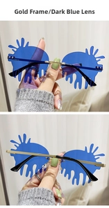 Macro view of gold metal bridge and dark blue liquid-shaped rimless lenses of sunglasses