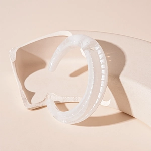 Close-up of marbled acrylic cuff bracelet with ribbed texture and C-shaped opening