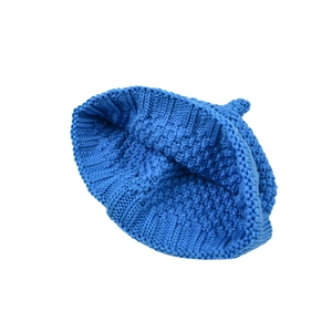 Macro shot of bright blue chunky knit texture and ribbed cuff on baby winter beanie