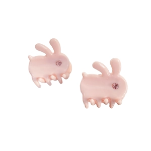 Pink acetate mini rabbit hair claws with sparkling rhinestone eyes set on white background