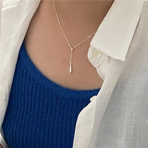 Close-up of minimalist S925 sterling silver Y-shaped necklace with drop pendant on model