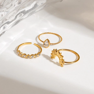 Three-piece set of gold-plated stainless steel rings with teardrop zircon and sunburst motif