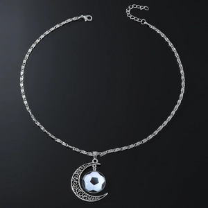 Hip hop silver necklace featuring a crescent moon and soccer pendant on black background