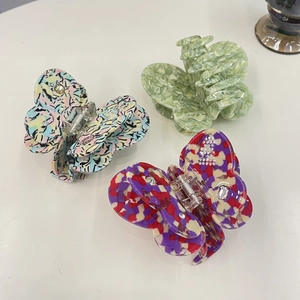 Elegant set of three butterfly acetate hair claws with colorful marble and gemstone patterns