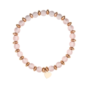 Close-up of pink beaded bracelet featuring a polished gold heart charm on white background
