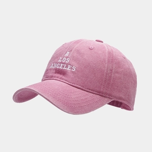 Close-up of pink washed cotton baseball cap with white A LOS ANGELES embroidery detail