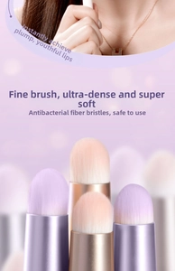 Detailed close-up of soft round head lipstick brush with dual-tone synthetic fibers