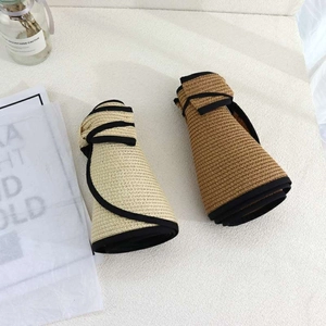 Detail view of the fine straw weave and foldable design of the beige sun visor hat