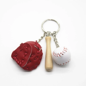 Close-up of baseball keychain set with leather glove, wooden bat and mini ball