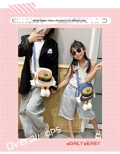Detail view of cartoon burger crossbody bags in off-white and navy for kids and adults