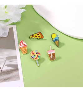 Detailed view of colorful enamel pins featuring pizza, ice cream and bubble tea designs
