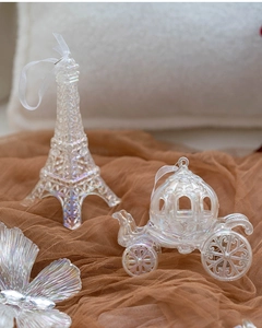 Iridescent Christmas tree ornaments featuring Eiffel Tower and pumpkin carriage designs