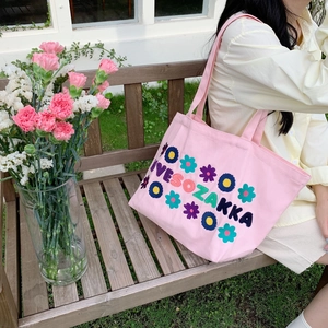 Close-up of pink canvas tote bag with floral embroidery and LOVESOZAKKA lettering