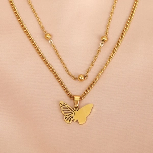 Double-layered gold stainless steel necklace with butterfly pendant on pink silk