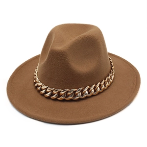 Close-up of brown wool fedora hat featuring a chunky gold chain strap detail