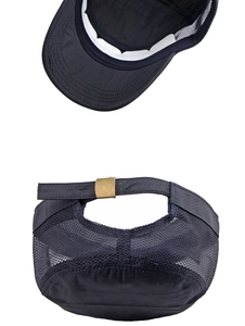 Detail view of black mesh flat top cap featuring adjustable bronze metal buckle back
