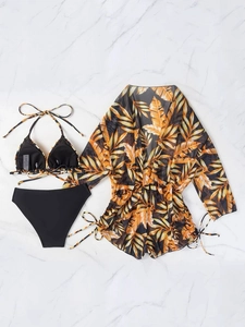 Close-up of three-piece bikini set with tropical palm leaf print mesh cover-up