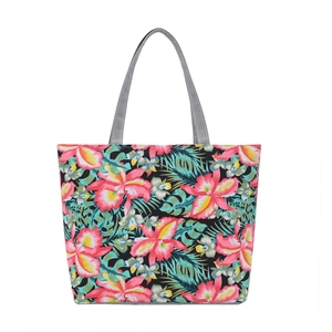 Large black canvas tote bag featuring vibrant pink floral prints and grey woven handles