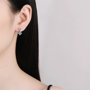 Classic S925 sterling silver heart stud earrings with 1 carat moissanite on model