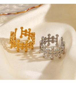 Detail view of gold and silver open rings with hollow lattice and bead accents