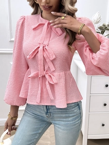 Pink plaid blouse detail featuring triple bow decoration and puff sleeves for women