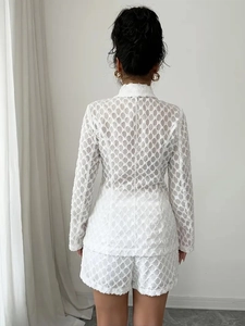 Rear view of white jacquard suit set featuring hollow fringe texture and elegant tailoring