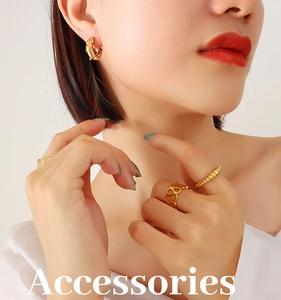 Close-up of elegant gold-plated C-shaped earrings with white pearls on a model