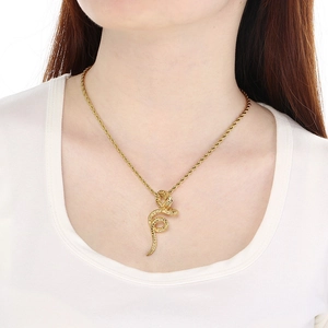 Close-up of 18k gold snake pendant with twisted rope chain on model neck