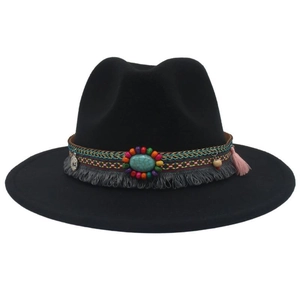 Detail of black felt fedora featuring colorful woven band, turquoise stone, and fringe