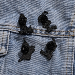 Funny red pepper cartoon brooches back view with black rubber clutches on denim jacket