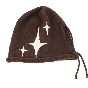 Detailed knit texture of dark brown beanie with white star patterns and drawstrings